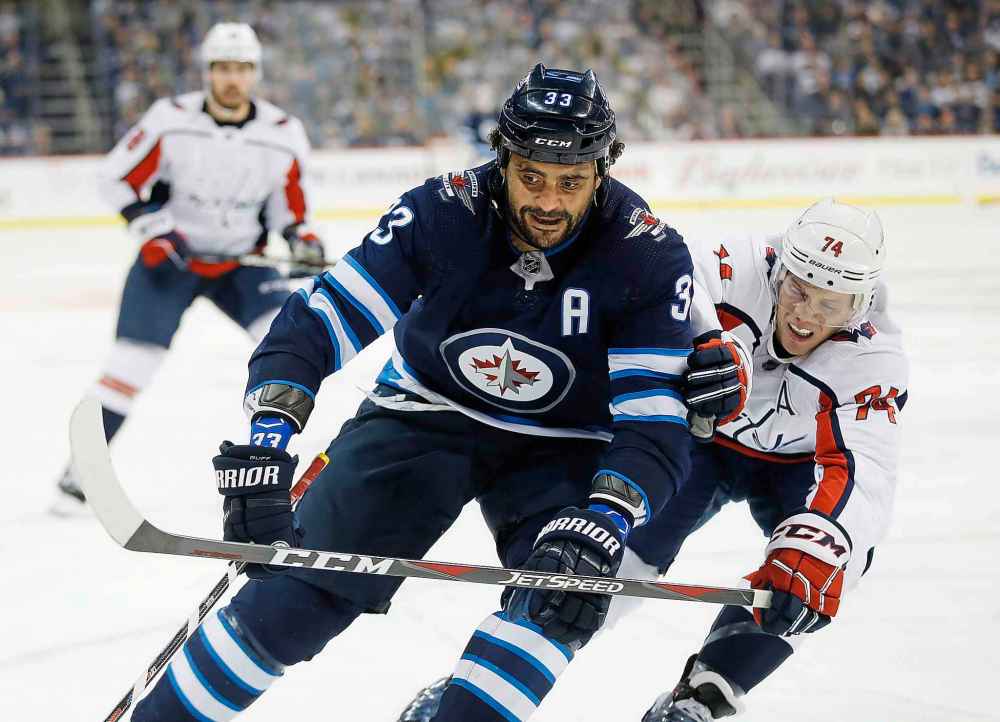 THE CANADIAN PRESS/John Woods
Winnipeg Jets' Dustin Byfuglien works his way around Washington Capitals' John Carlson during the second period.