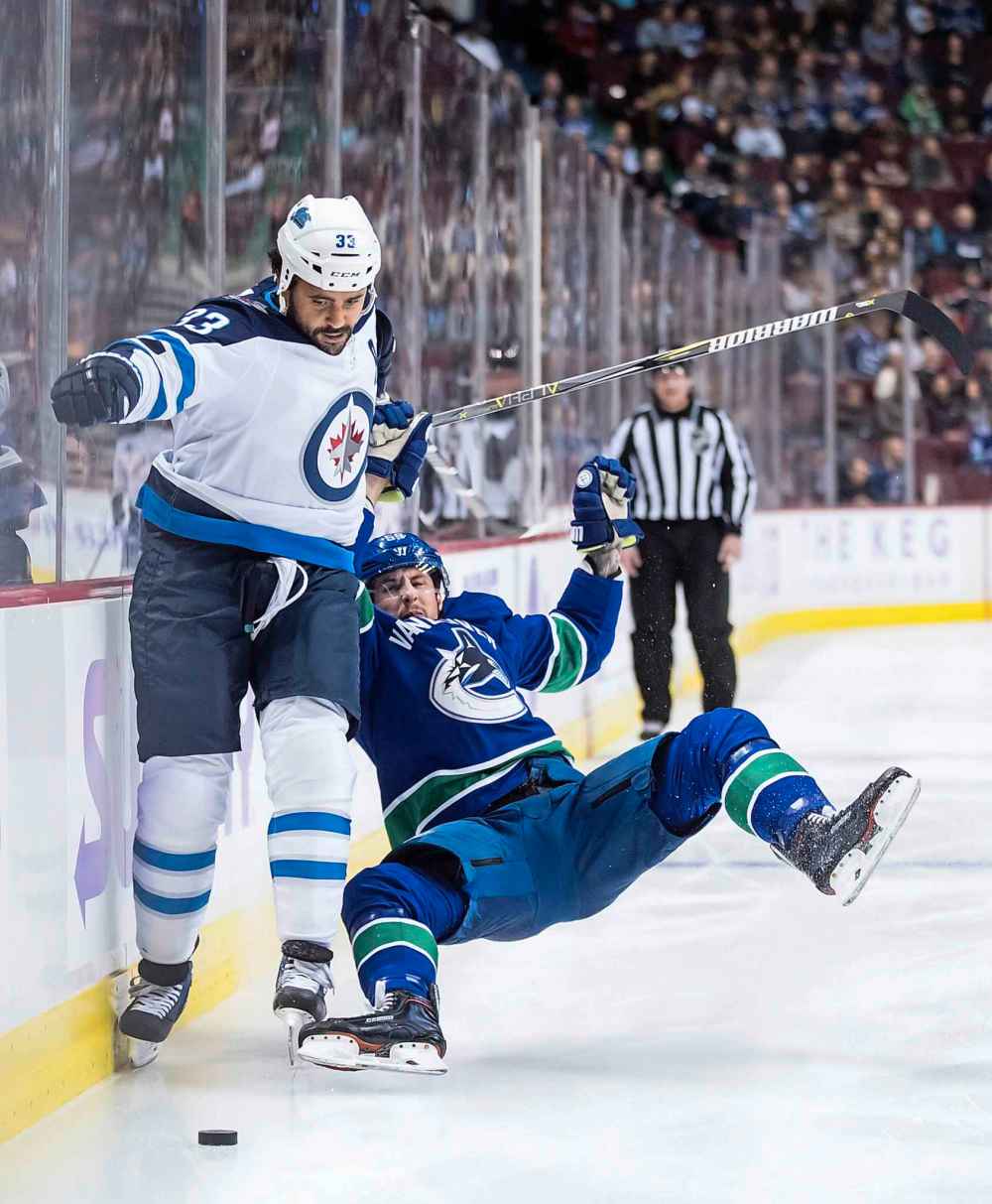 THE CANADIAN PRESS/Darryl Dyck
Winnipeg Jets' Dustin Byfuglien fights off Vancouver Canucks' Tim Schaller during the first period Monday.
