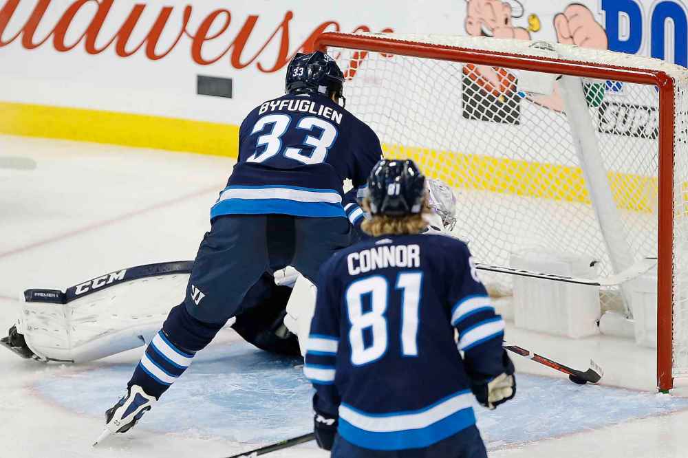 THE CANADIAN PRESS/John Woods
A Washington Capitals shot bounces off Winnipeg Jets goaltender Connor Hellebuyck toward the goal line but Dustin Byfuglien reached in and stopped the puck on the line during third period Wednesday.