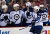 EVEN VUCCI / THE ASSOCIATED PRESS
Jets right wing Spencer Machacek (46) high-fives along the bench after scoring the game-tying goal against the Capitals in the third period Friday.