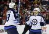 Alex Brandon / The Associated Press
Dustin Byfuglien celebrates with centre Jim Slater after Slater's goal in the second period against the Washington Capitals.