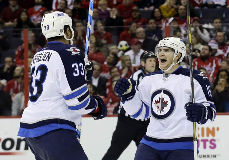 Alex Brandon / The Associated Press
Dustin Byfuglien celebrates with centre Jim Slater after Slater's goal in the second period against the Washington Capitals.