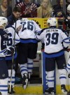 Nick Wass / the associated press files
Winnipeg Jets right wing Blake Wheeler (26) is helped to the bench by Tobias Enstrom (39) and others after he took a shot inside the left knee during the third period of Thursday's game against the Capitals in Washington.