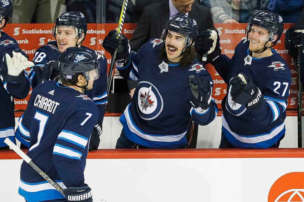 THE CANADIAN PRESS/John Woods
Winnipeg Jets players celebrate Ben Chiarot's game-winning goal against the Washington Capitals in the third period in Winnipeg on Wednesday.