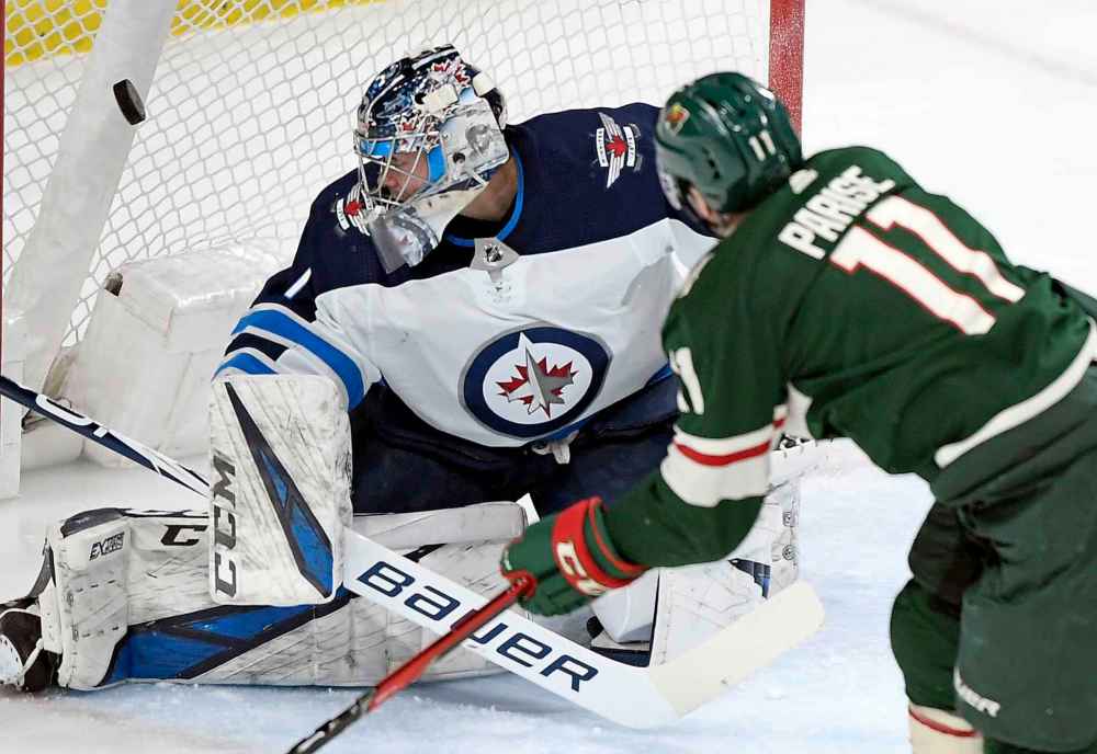 (AP Photo/Hannah Foslien)
Minnesota Wild left wing Zach Parise scores his second goal against Winnipeg Jets goaltender Eric Comrie during the first period.