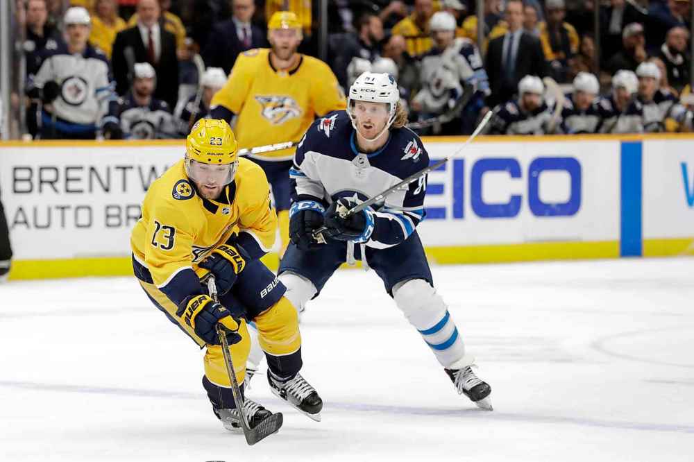 (AP Photo/Mark Humphrey)
Nashville Predators right wing Rocco Grimaldi moves the puck against Winnipeg Jets left wing Kyle Connor in the second period.