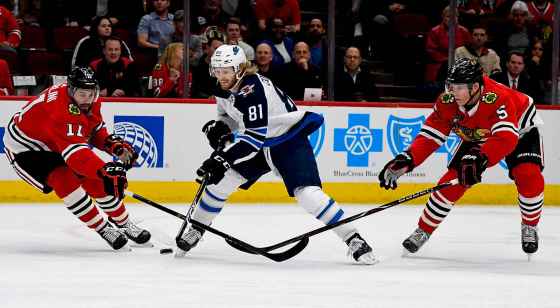(AP Photo/Matt Marton)Winnipeg Jets left wing Kyle Connor fights for the puck against Chicago Blackhawks Brendan Perlini and Connor Murphy during the first period Monday in Chicago.