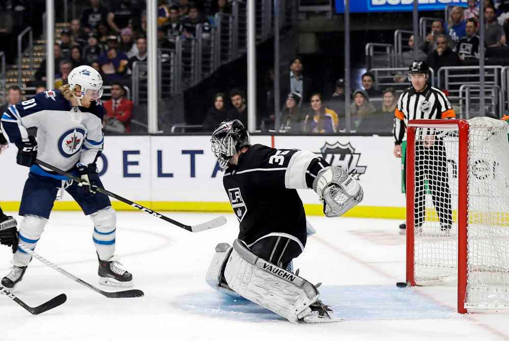 (AP Photo/Marcio Jose Sanchez)
Winnipeg Jets' Kyle Connor, left, scores on Los Angeles Kings goaltender Jack Campbell, front right, during the first period.