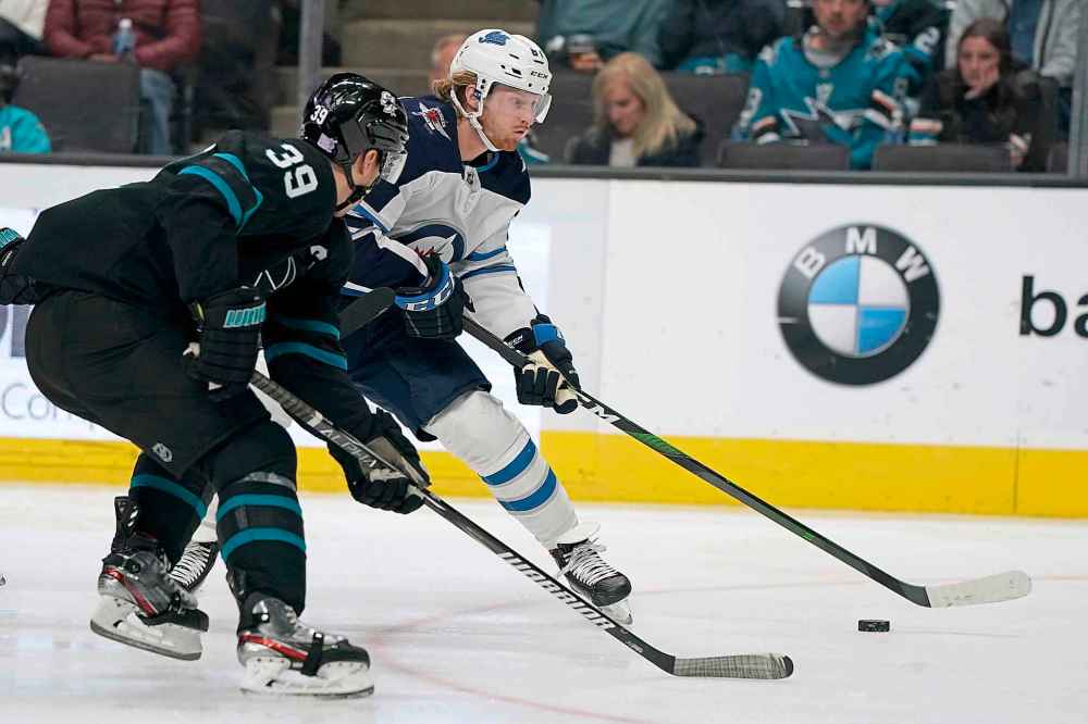 (AP Photo/Tony Avelar)
Winnipeg Jets left wing Kyle Connor works for the puck against San Jose Sharks centre Logan Couture during the second period.