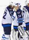 Rich Schultz / The Associated Press
Winnipeg Jets forward Chris Thorburn (22) congratulates goalie Michael Hutchinson (34) after their 3-1 win over the New Jersey Devils in an NHL hockey game in Newark, N.J.
