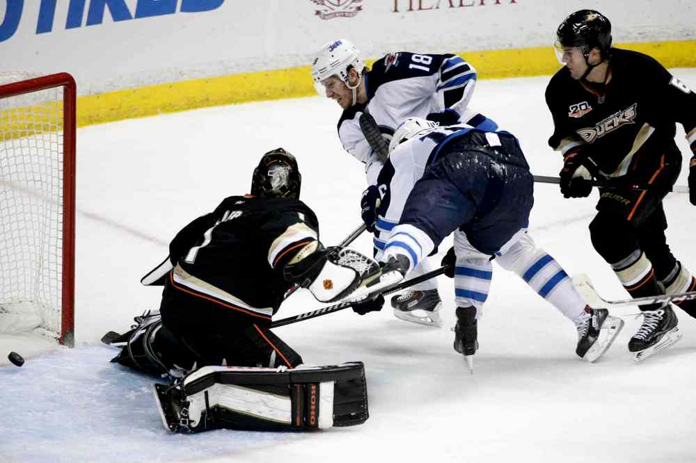 Jae C. Hong
Winnipeg Jets' Bryan Little (18) scores against Anaheim Ducks' goalie Jonas Hiller (1), as Ducks' Ben Lovejoy (6) watches during the first period of the NHL hockey game in Anaheim, Calif. Tuesday.