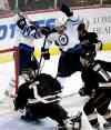 Jae C. Hong / The Associated Press
Jets' captain Andrew Ladd celebrates his first-period goal as Bryan Little gets a stick to the face. The Jets won the game 3-2.