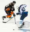 Kevin Sullivan / The Orange County Register / The Associated Press
Anaheim Ducks right wing Corey Perry (10) loses the puck to the defense of Winnipeg Jets defenseman Ben Chiarot (63) during the first period of the opening round game of Stanley Cup playoffs at the Honda Center on Thursday.