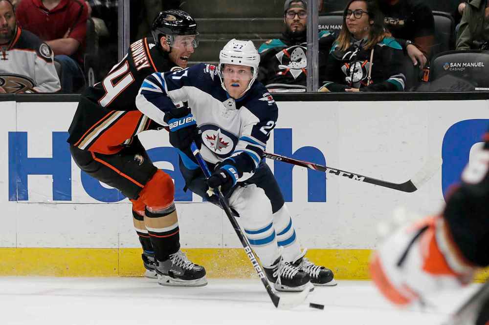 (AP Photo/Alex Gallardo)
Winnipeg Jets left wing Nikolaj Ehlers skates past Anaheim Ducks right wing Carter Rowney with the puck during the first period.