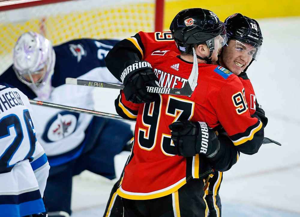 THE CANADIAN PRESS/Jeff McIntosh
Calgary Flames' Sam Bennett, centre, celebrates his goal with teammate Matthew Tkachuk, right, during the first period in Calgary, Wednesday.
