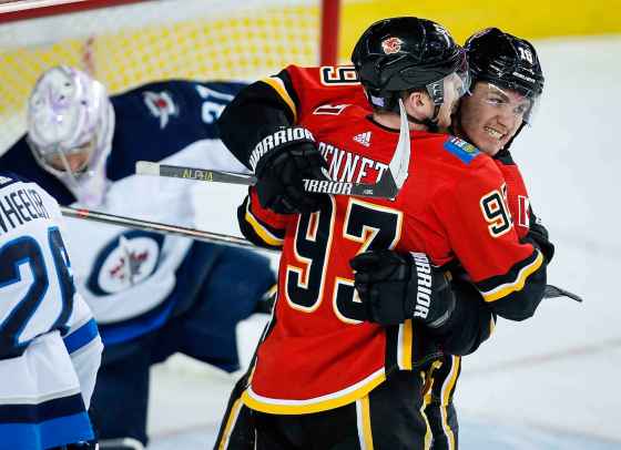 THE CANADIAN PRESS/Jeff McIntoshCalgary Flames' Sam Bennett, centre, celebrates his goal with teammate Matthew Tkachuk, right, during the first period in Calgary, Wednesday.