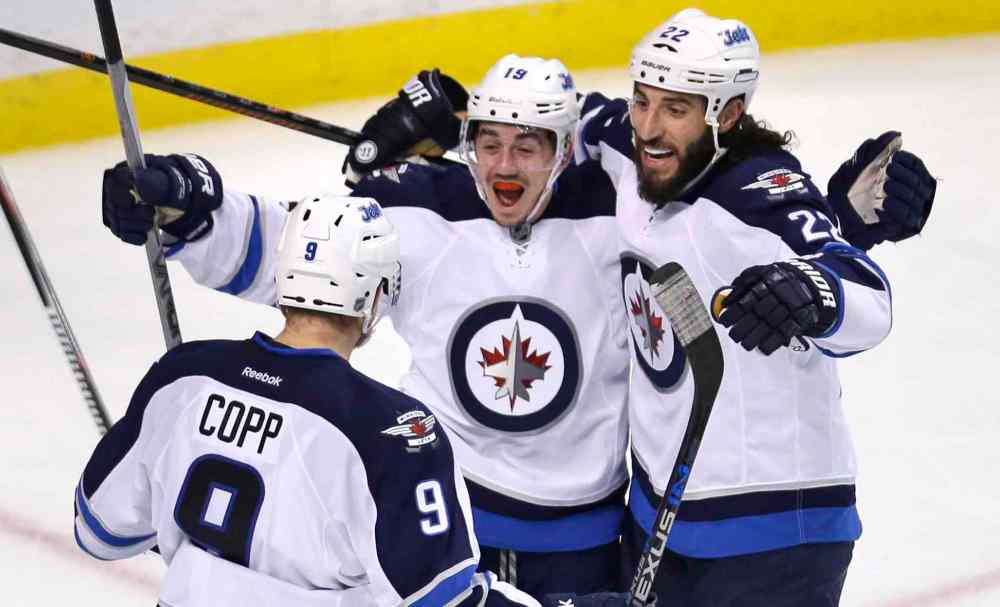 Charles Krupa / The Associated Press
Winnipeg Jets center Nicolas Petan, center, celebrates with Chris Thorburn (22) and Andrew Copp (9) after his goal against Boston Bruins goalie Tuukka Rask, Thursday, Oct. 8.