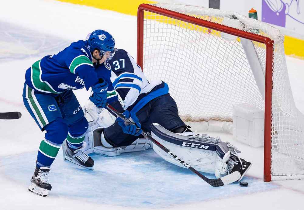 THE CANADIAN PRESS/Darryl Dyck
Vancouver Canucks' Nikolay Goldobin scores on Jets goalie Connor Hellebuyck during the second period Monday.