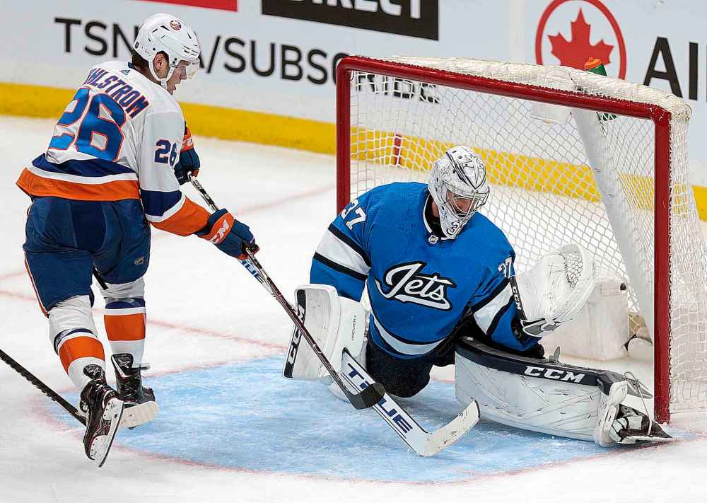 PHIL HOSSACK / WINNIPEG FREE PRESS
Winnipeg Jets netminder Connor Hellebuyck foils New York Islanders' Oliver Wahlstrom in the second period Thursday.