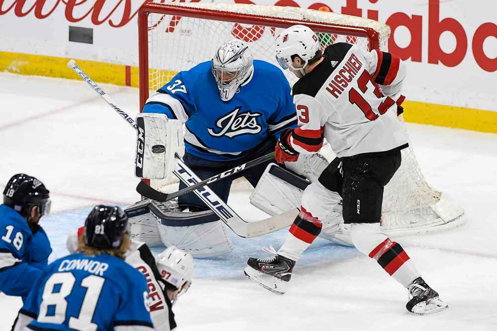 THE CANADIAN PRESS/Fred Greenslade
Jets' goaltender Connor Hellebuyck makes a save on New Jersey Devils' Nico Hischier during the first period.