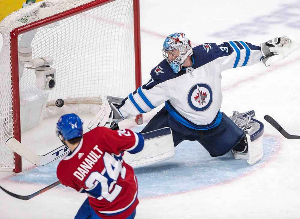 THE CANADIAN PRESS/Ryan Remiorz
Montreal Canadiens center Phillip Danault scores the fourth goal against Winnipeg Jets goaltender Connor Hellebuyck during the third period NHL hockey action Thursday, in Montreal.