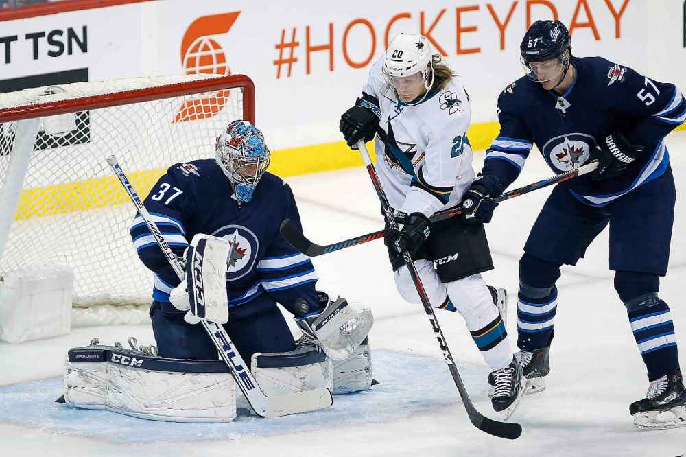 JOHN WOODS / WINNIPEG FREE PRESS
San Jose Sharks' Marcus Sorensen attempts to deflect the puck past Winnipeg Jets goaltender Connor Hellebuyck as Tyler Myers defends during the first period.