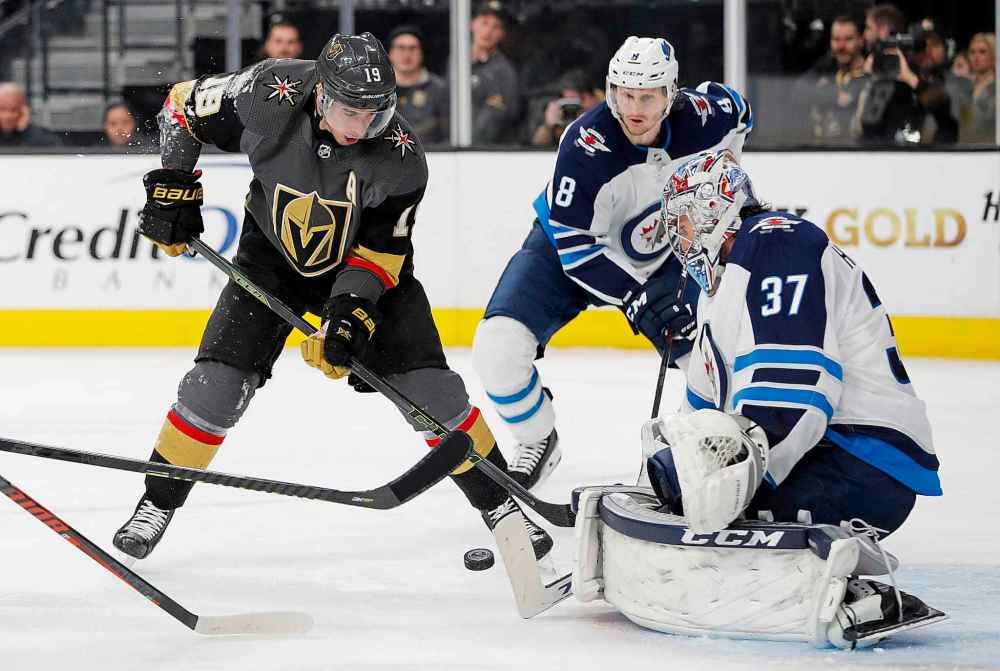 (AP Photo/John Locher)
Winnipeg Jets goaltender Connor Hellebuyck blocks a shot by Vegas Golden Knights right wing Reilly Smith during the second period.