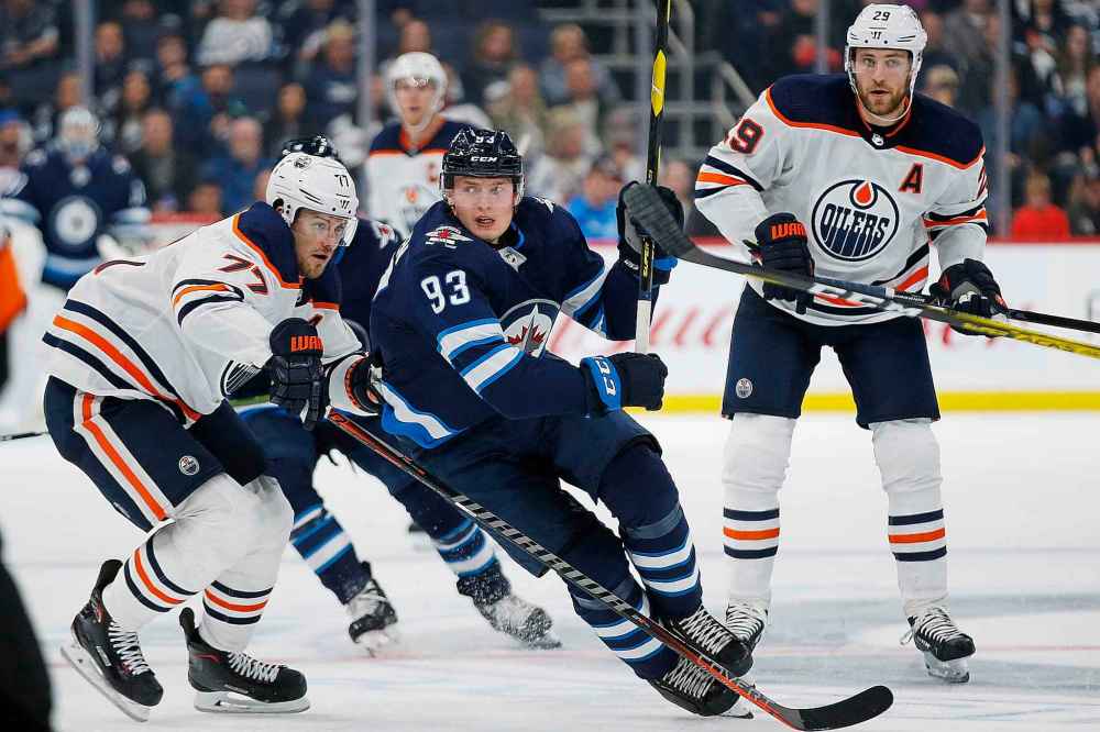 THE CANADIAN PRESS/John Woods
Winnipeg Jets left wing Kristian Vesalainen and Edmonton Oilers defenceman Oscar Klefbom race for the puck during the second period in Winnipeg on Thursday.