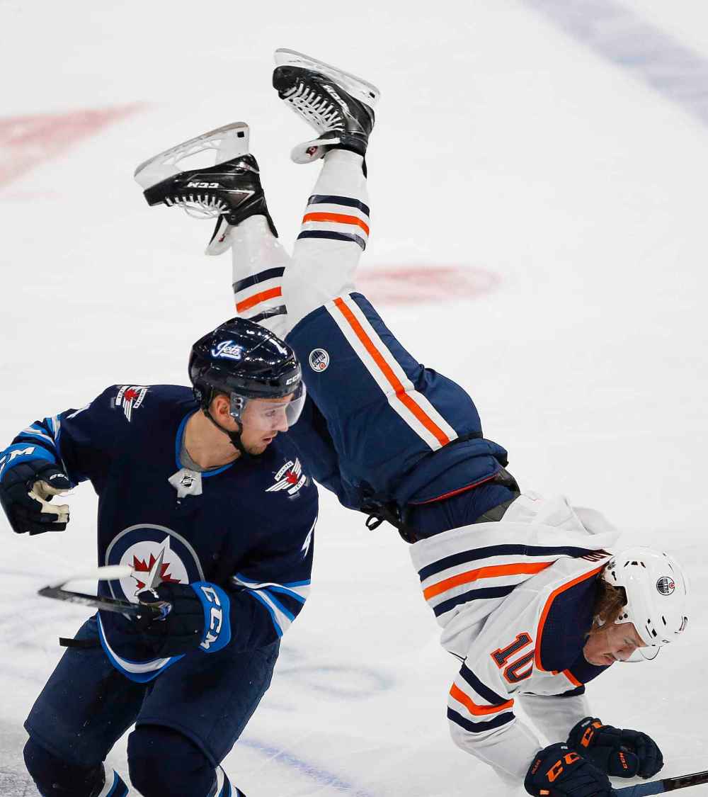 THE CANADIAN PRESS/John Woods
Winnipeg Jets defenceman Neal Pionk checks Edmonton Oilers left wing Joakim Nygard in the neutral zone during the first period, Thursday.