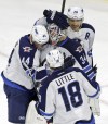 Gerry Broome / The Associated Press 
Winnipeg Jets' Zach Bogosian (44), Bryan Little (18) and Blake Wheeler (26) congratulate goalie Michael Hutchinson (34) following the Jets' 3-1 win over the Carolina Hurricanes Thursday.