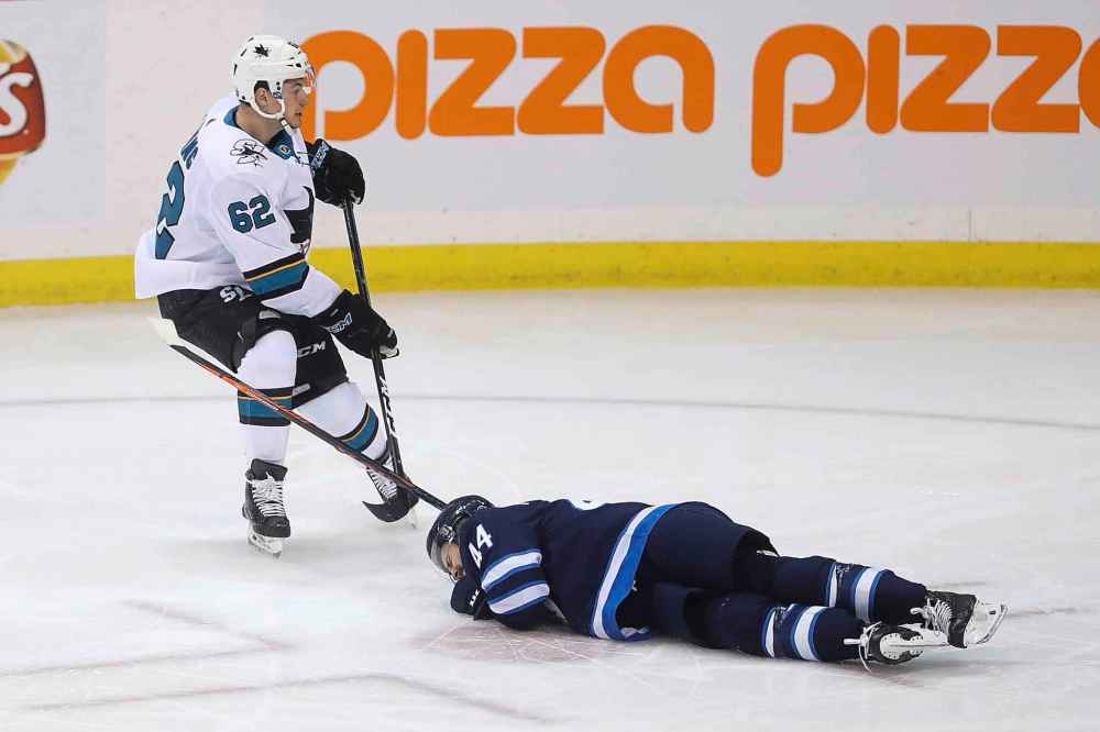THE CANADIAN PRESS/Trevor Hagan
Winnipeg Jets' Josh Morrissey on the ice after blocking a shot as San Jose Sharks' Kevin Labanc .