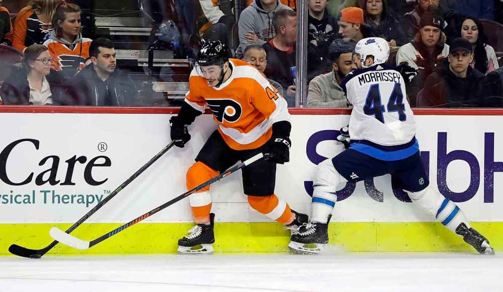 (AP Photo/Matt Slocum)
Philadelphia Flyers' Phil Varone, left, chases after the puck after a collision with Winnipeg Jets' Josh Morrissey during the second period.