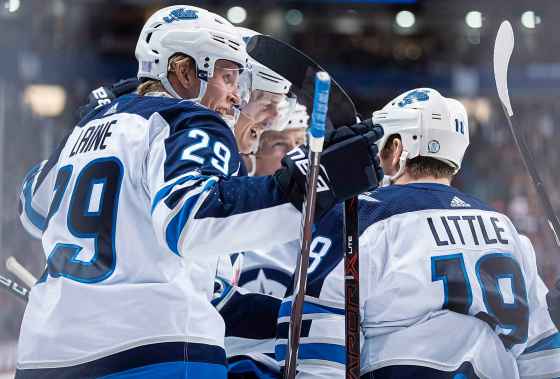 THE CANADIAN PRESS/Darryl DyckWinnipeg Jets' Patrik Laine, left, Tyler Myers, second left, Joe Morrow, back and Bryan Little celebrate Little's goal against the Vancouver Canucks during the first period  in Vancouver, on Monday.