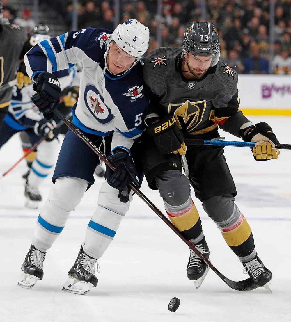 (AP Photo/John Locher)
Winnipeg Jets defenceman Dmitry Kulikov and Vegas Golden Knights centre Brandon Pirri vie for the puck during the second period.