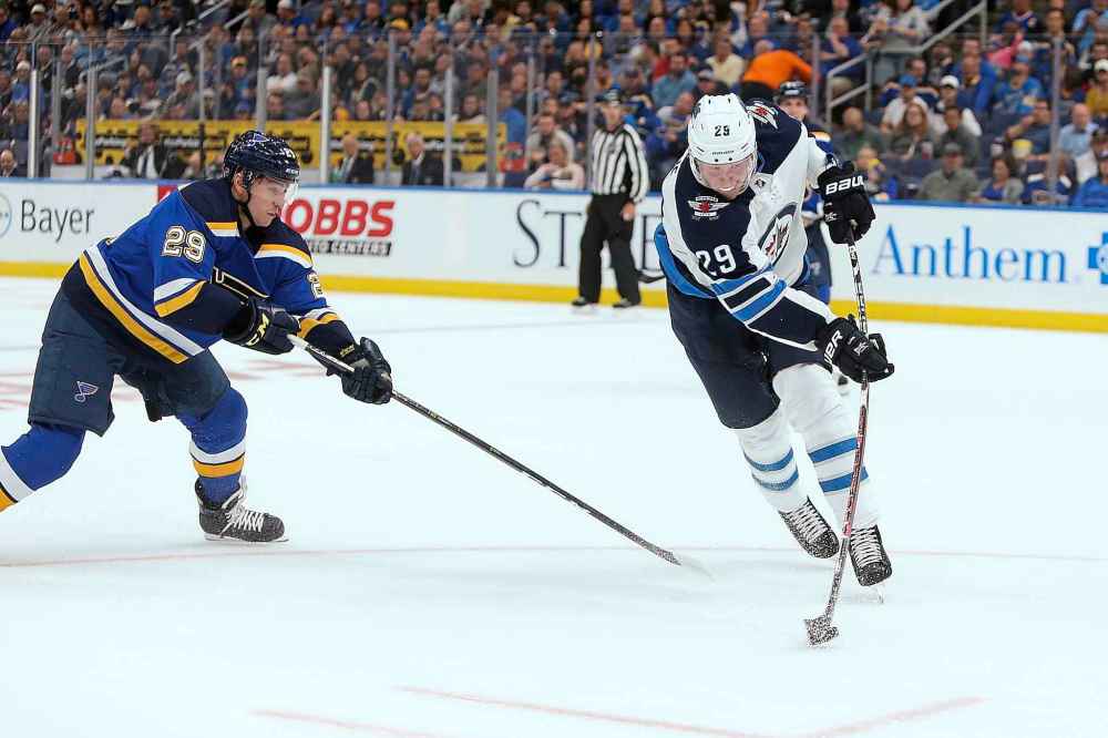 (AP Photo/Scott Kane)
Jets right wing Patrik Laine takes a shot on goal while being pursued by St. Louis Blues defenceman Vince Dunn during the first period Thursday.