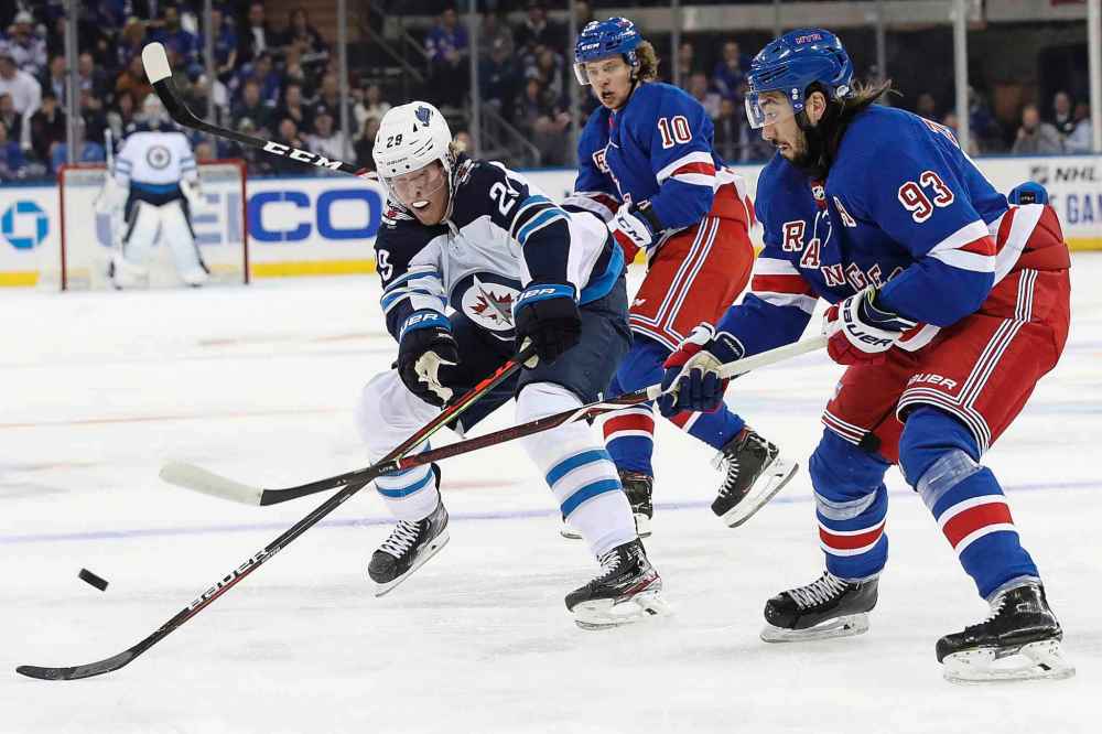 (AP Photo/Mary Altaffer)
Winnipeg Jets right wing Patrik Laine skates against New York Rangers centre Mika Zibanejad during the first period Thursday in New York.