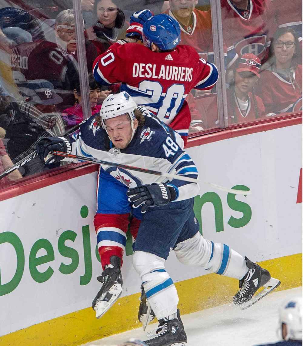 THE CANADIAN PRESS/Ryan Remiorz
Winnipeg Jets left wing Brendan Lemieux checks Montreal Canadiens left wing Nicolas Deslauriers during the first period.