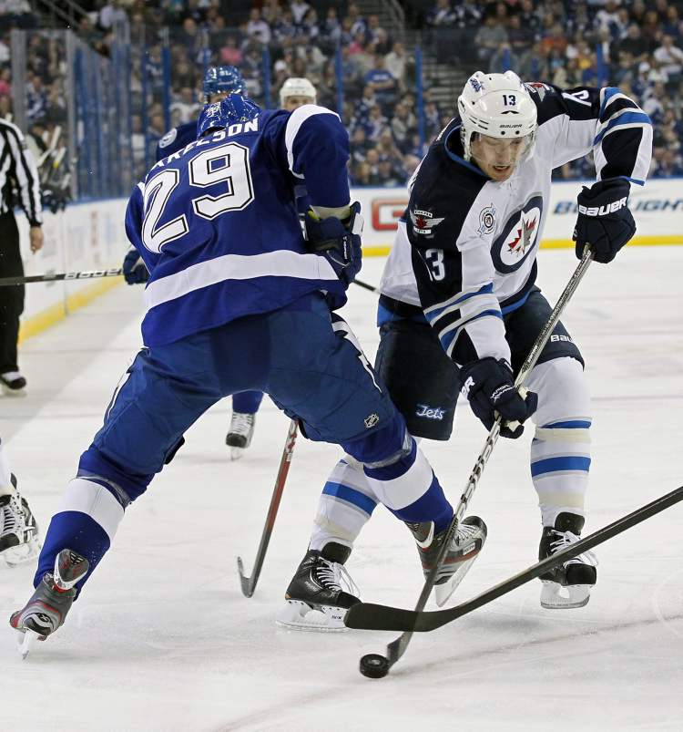 Mike Carlson / The Associated Press Archives
Winnipeg Jets' Kyle Wellwood, right, has returned to practice with the team following time away due to illness.
