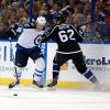 Mike Carlson / The Associated Press
The Jets Jiri Tlusty by Andrej Sustr of the Lightning.