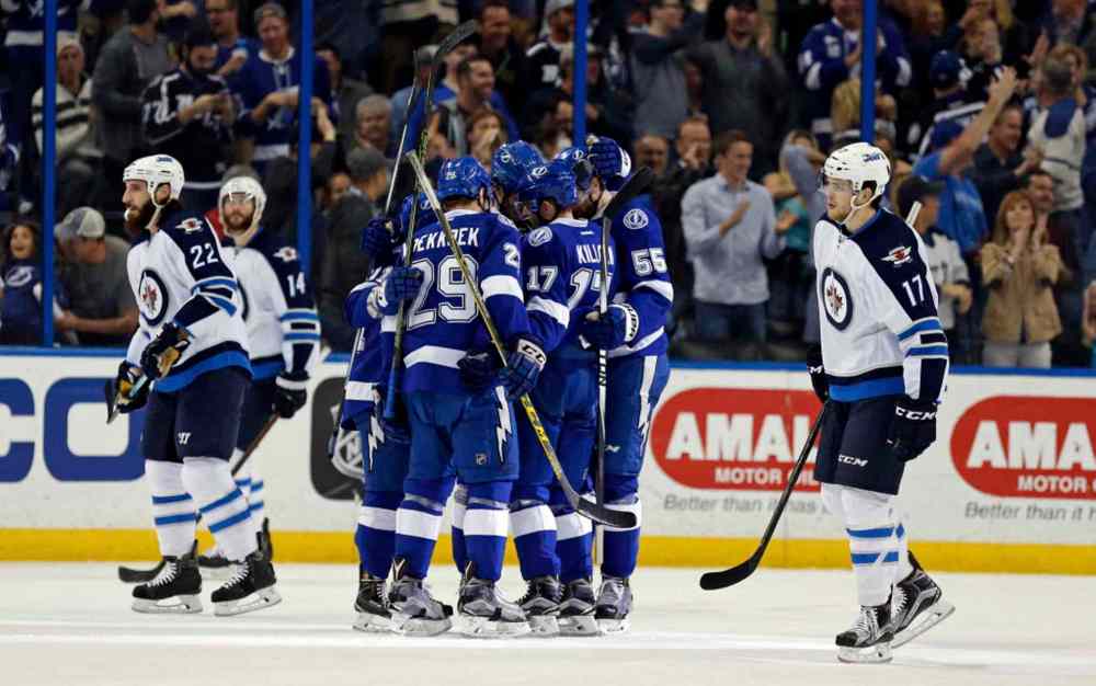 Mike Carlson / The Associated Press
Tampa Bay Lightning players celebrate a goal as Winnipeg Jets react during the first period Thursday in Tampa, Fla. The Winnipeg Jets trail the Tampa Bay Lightning, 3-1, after two periods of play at Amalie Arena Thursday night.
After Victor Hedman, Jonathan Marchessault and Steven Stamkos all scored in the final five minutes of the first period to put the homeside up 3-zip, the Jets won the second period thanks to a goal from defenceman Tyler Myers at the 13:45 mark of the frame.
The game turned physical after the Jets' goal after Bryan Little took a hit by Lightning defenceman Anton Stralman, leaving him lying injured on the ice. Blake Wheeler eventually dropped the gloves with Stralman and once the smoke had cleared Tampa was given a two-man advantage but were unable to score on the 5-on-3 power play.
Ondrej Pavelec finishes with 13 saves through two periods, while Adrei Vasilevskiy has stopped 21 of 22 shots from the Jets.