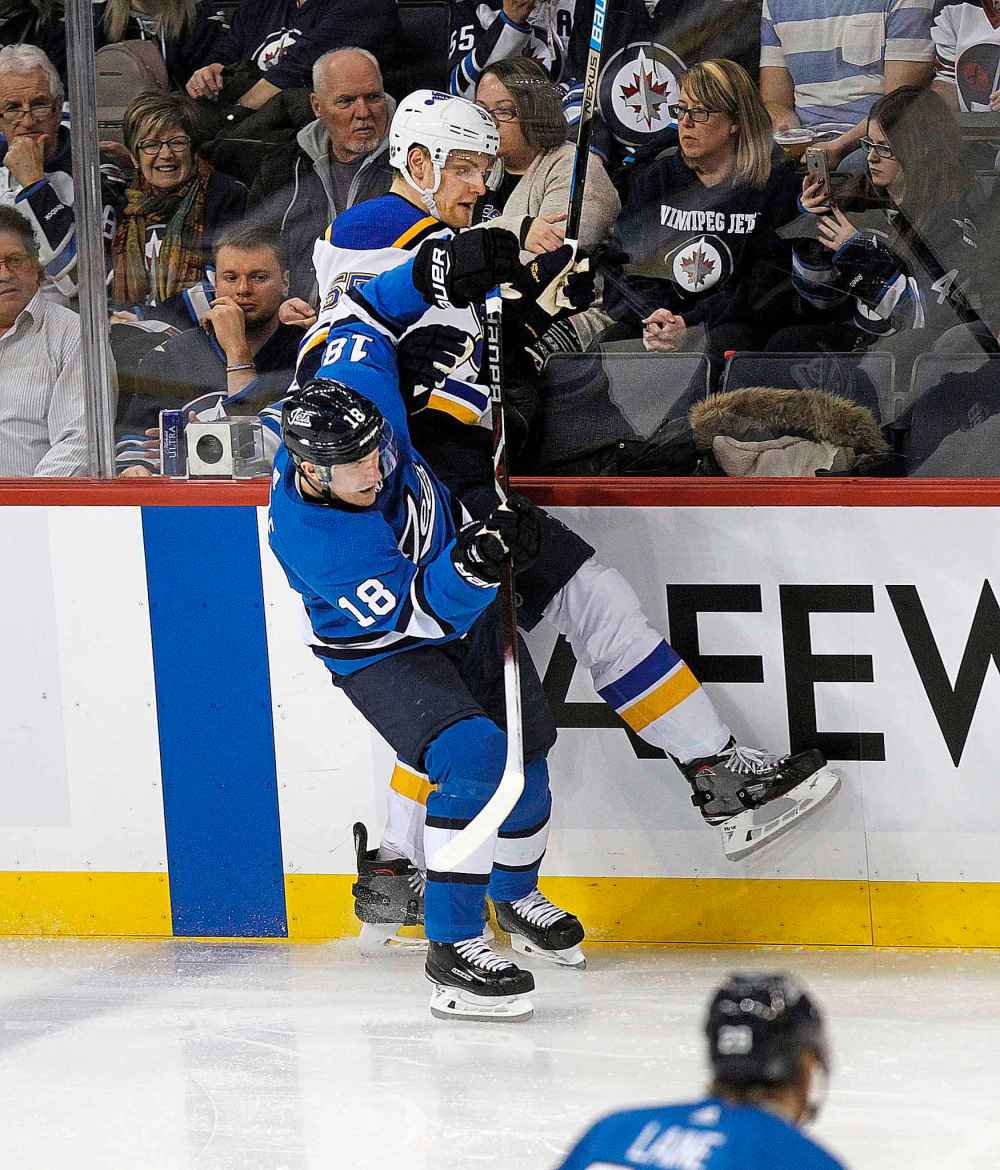 Phil Hossack / Winnipeg Free Press
St. Louis Blues Colton Parayko takes a hit from Winnipeg Jets' Bryan Little Friday.