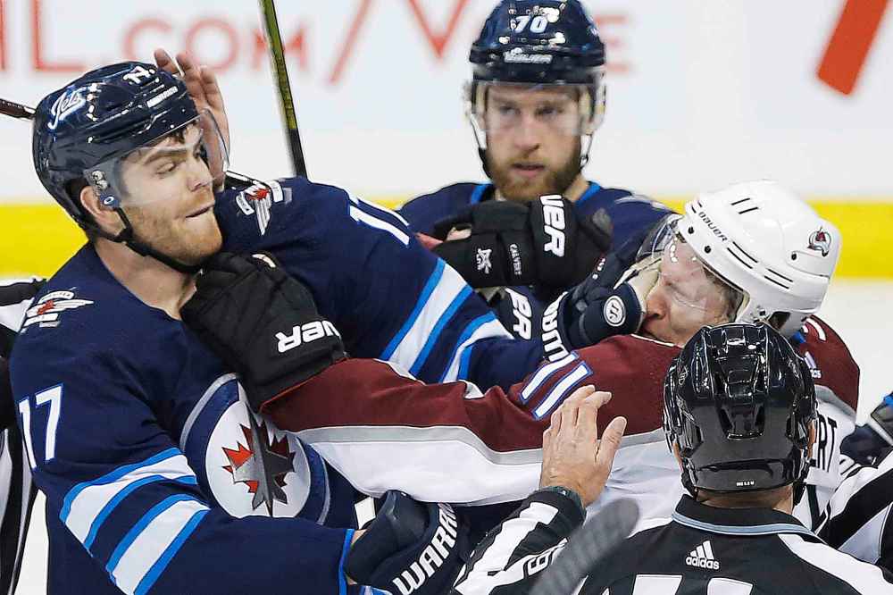 JOHN WOODS / WINNIPEG FREE PRESS
Winnipeg Jets' Adam Lowry lands one to the face of Colorado Avalanche's Matt Calvert as Jets' Joe Morrow looks on during the second period.