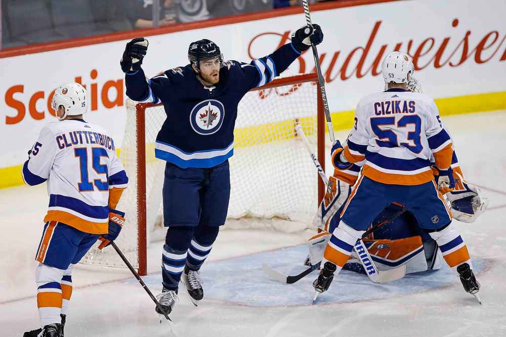 THE CANADIAN PRESS/John Woods
Winnipeg Jets' Adam Lowry celebrates his goal on New York Islanders goaltender Robin Lehner 13 seconds into the game in Winnipeg on Thursday.