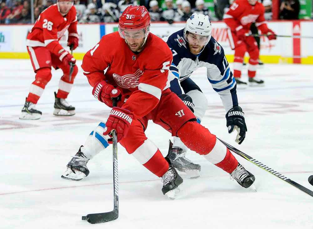 (AP Photo/Duane Burleson)
Detroit Red Wings center Frans Nielsen maintains control of the puck against Winnipeg Jets center Adam Lowry during the second period Friday.