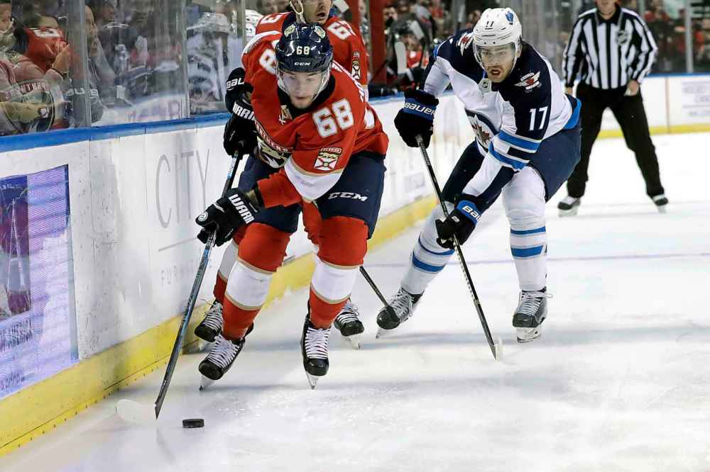 (AP Photo/Lynne Sladky)
Florida Panthers centre Mike Hoffman skates with the puck with Winnipeg Jets' Adam Lowry in pursuit during the first period.