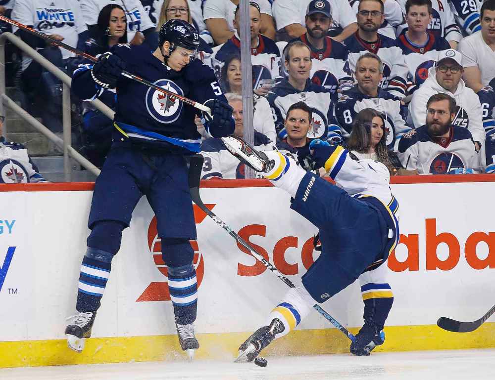 THE CANADIAN PRESS/John Woods
Winnipeg Jets defenceman Tyler Myers checks St. Louis Blues left wing Zach Sanford during the first period.