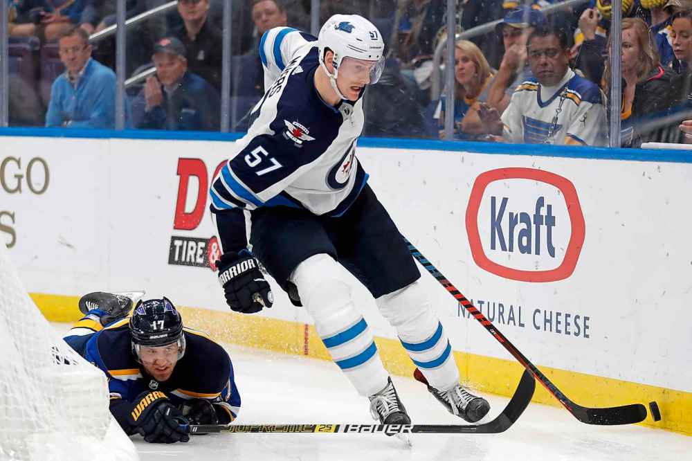 (AP Photo/Jeff Roberson)
Winnipeg Jets defenceman Tyler Myers moves the puck past the reach of St. Louis Blues left wing Jaden Schwartz during overtime.