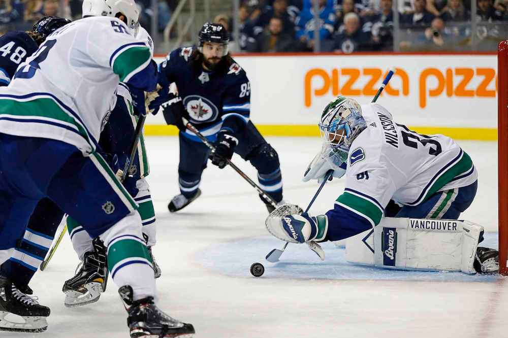 THE CANADIAN PRESS/John Woods
Vancouver Canucks goaltender Anders Nilsson jumps on the rebound from Winnipeg Jets' Brendan Lemieux's shot during second period.