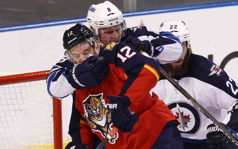 CP
Winnipeg Jets' Jacob Trouba (8) wrestles Florida Panthers' Jimmy Hayes (12) away from the net during the first period of Thursday's game.