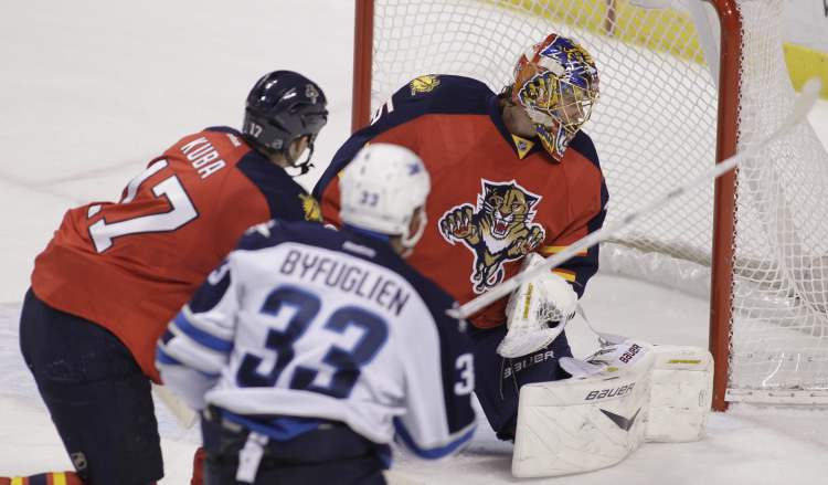 Luis M. Alvarez / The Associated Press
Winnipeg Jets' Dustin Byfuglien scores the OT winner on Florida Panthers' goalie Jacob Markstrom in Sunrise, Fla., on Friday night.